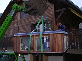 Chalet Peloton's new spa being lifted in place