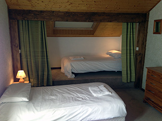 A top floor bedroom with walk in wardrobe.