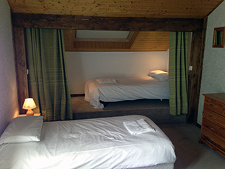 A top floor bedroom with walk in wardrobe.